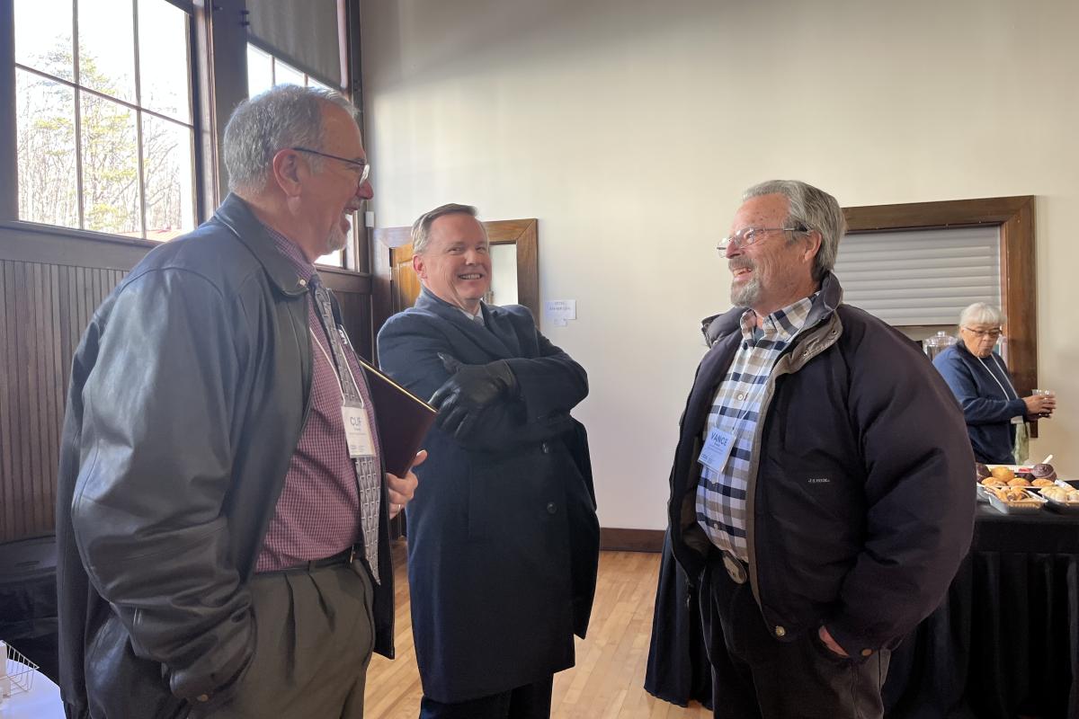 Men Stand Together and Chat at the Economic Development Summit